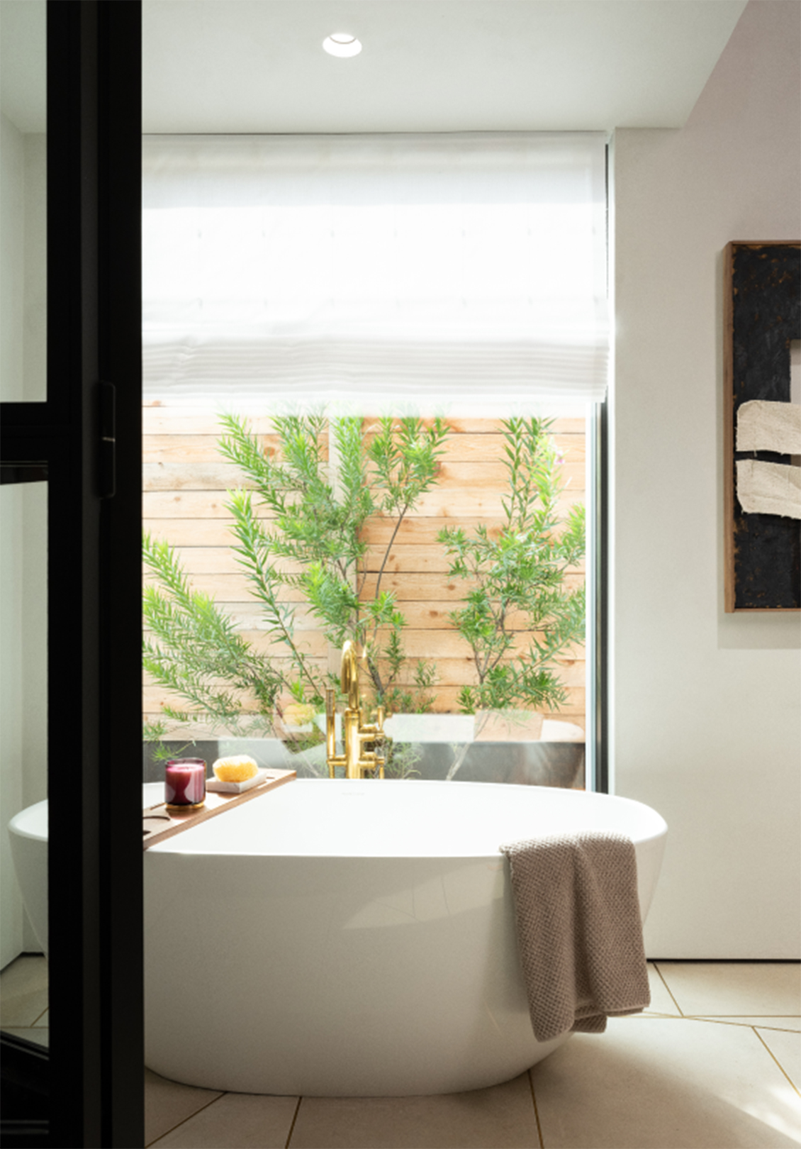 Light-filtering roman shades over a serene bath full of natural light in the daytime