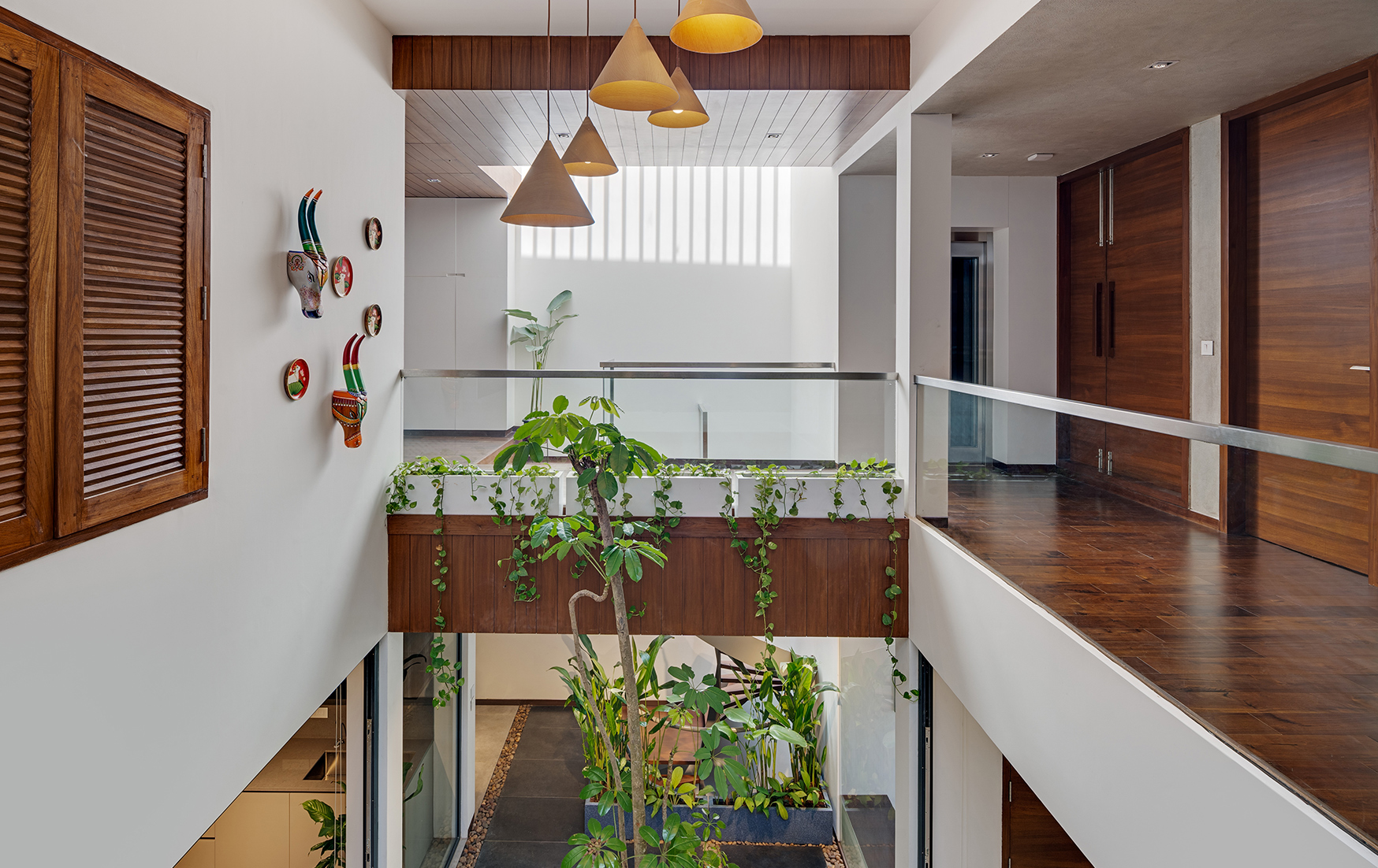 Entryway with biophilic design, balancing natural and electric light over a plant display