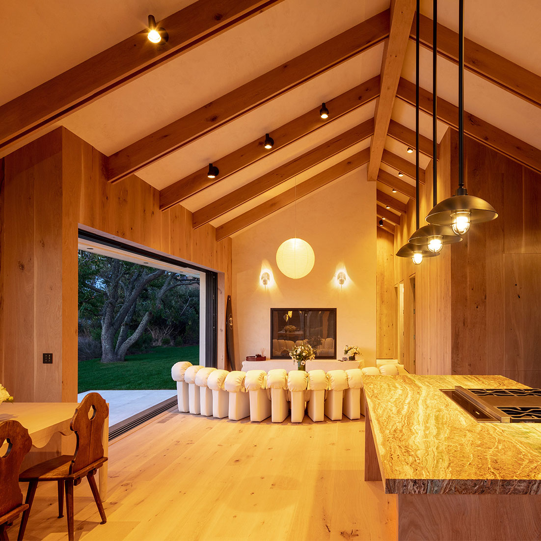 A barn house showing ambient lighting layer through natural daylight and task lighting layer with pendants