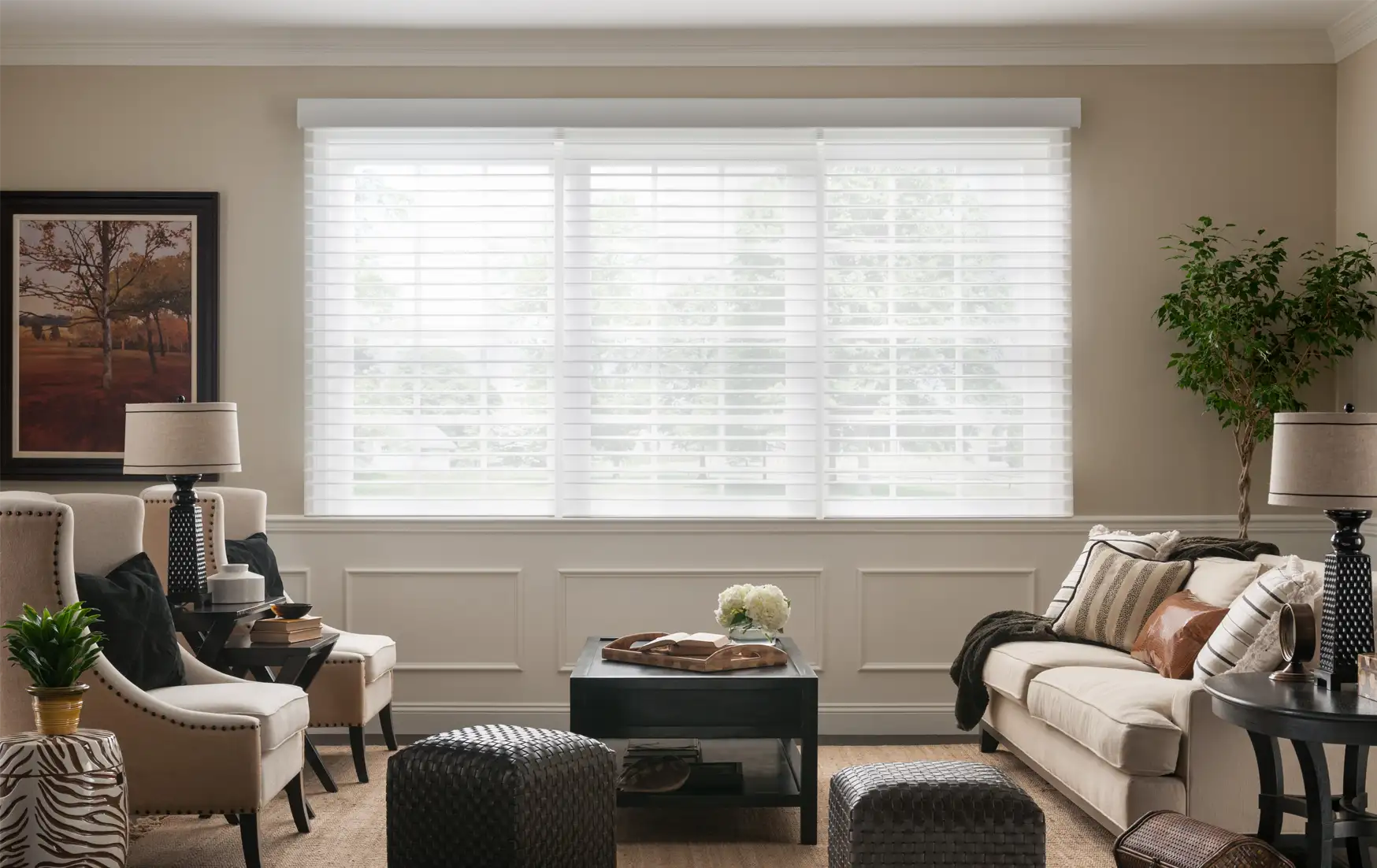 Automated horizontal sheer blinds filter sunlight while maintaining an outside view in living room setting.
