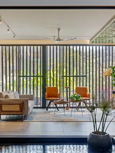 Biophilic lighting design leveraging natural light throughout living room space.