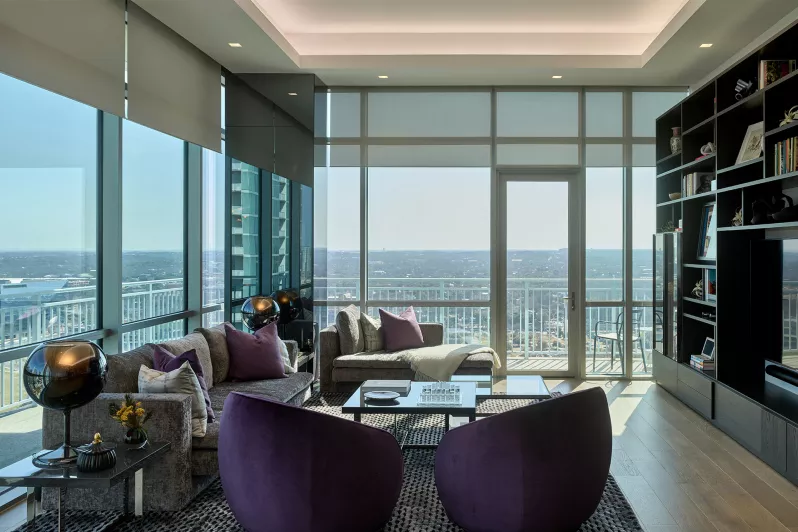 Sheer roller shades balancing natural light and view preservation in living room.