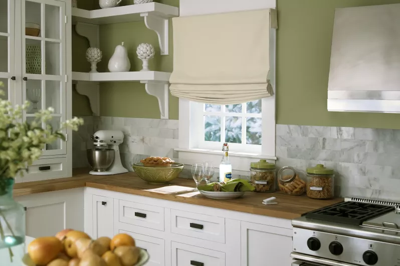 Automated roman shades in room-darkening fabric to provide privacy in kitchen