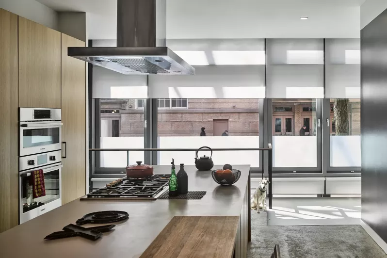 Kitchen with roller shades in a light fabric