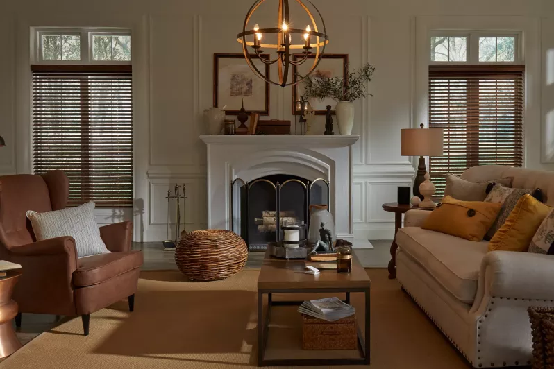 Wood blinds with intelligent tilt alignment balance views and privacy in living room, with decorative light fixture at center