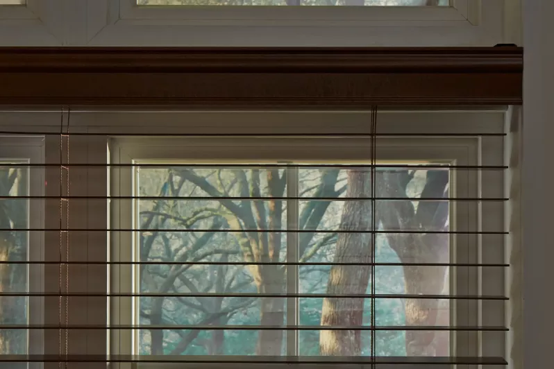 Close up of automated wood blinds creating a warm, natural atmosphere