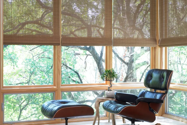 Automated roman shades with open weave fabric to preserve views in bedroom