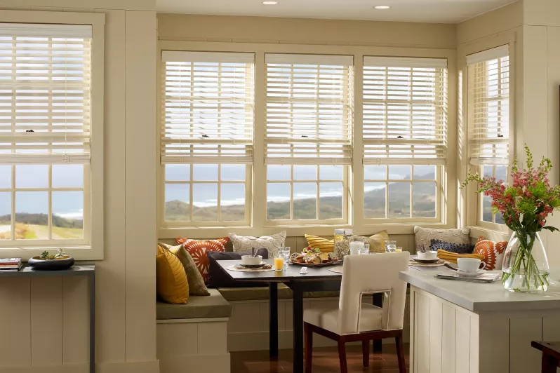 Wood blinds with intelligent hembar alignment balance views and daylight control in kitchen dining cove