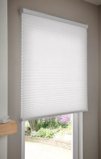 Automated cellular shades in bathroom setting provide privacy while allowing natural light through light-filtering fabrics