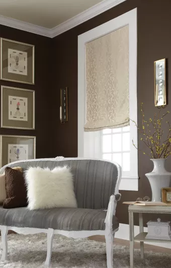 Roman shades' soft structure complements decorative fabric in living room setting