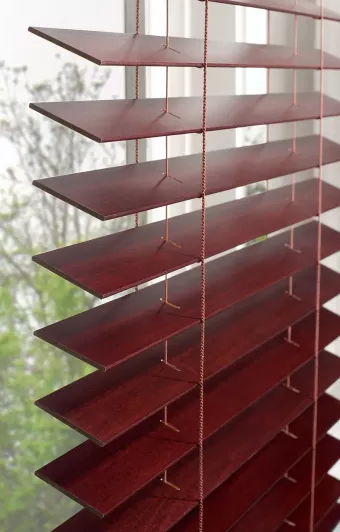 Close up of automated wood blinds creating a warm, natural atmosphere